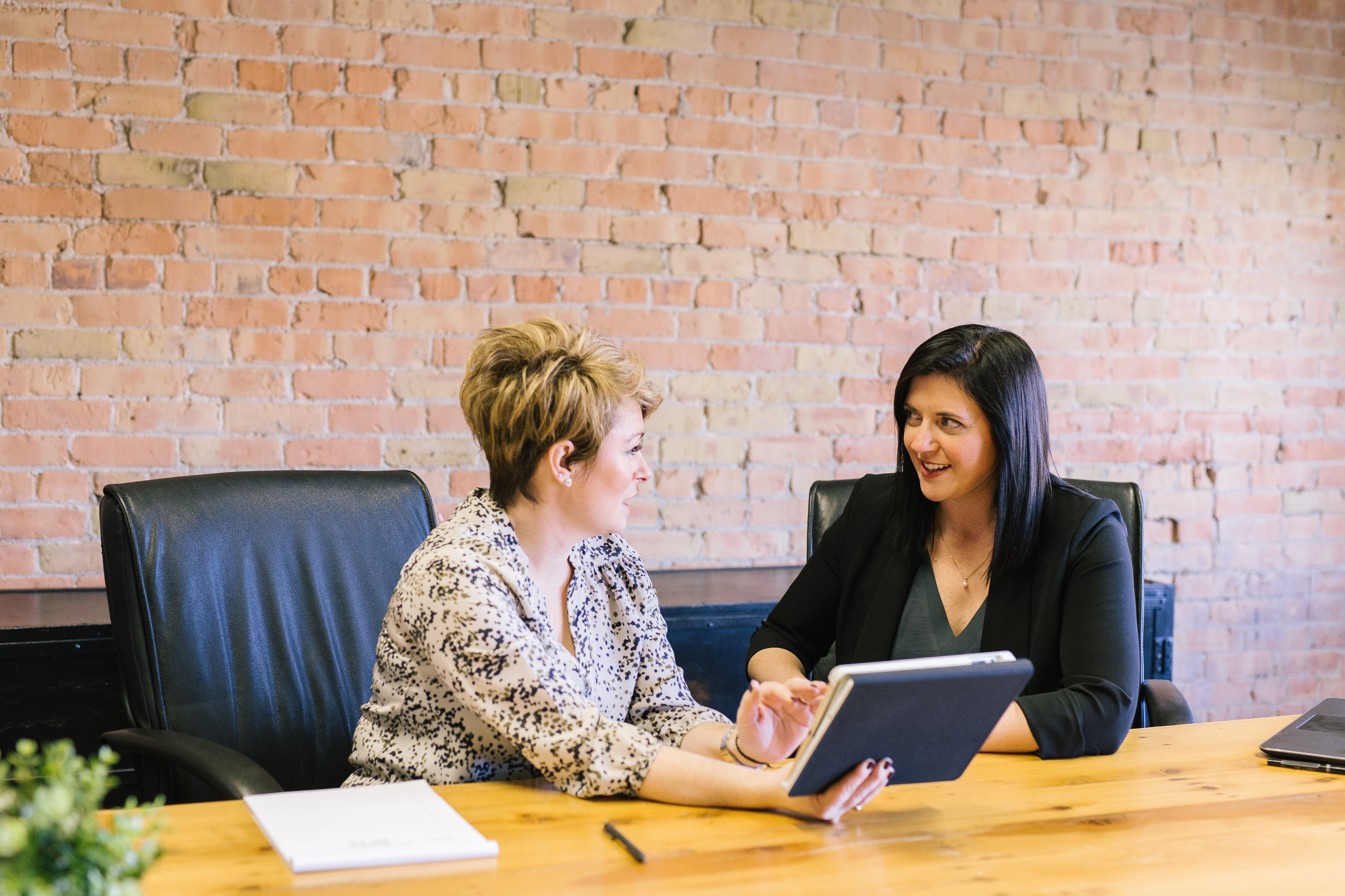 two woman talking and having a business meeting