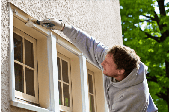 painter working on exterior home maintenance