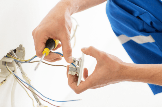 Close up of Hands with Screwdriver Fixing Socket 